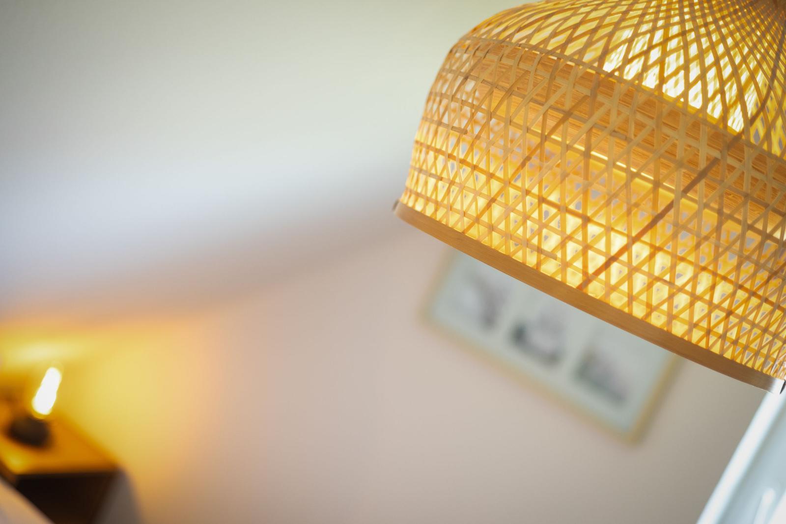A hanging lamp with a bamboo frame and warm light.