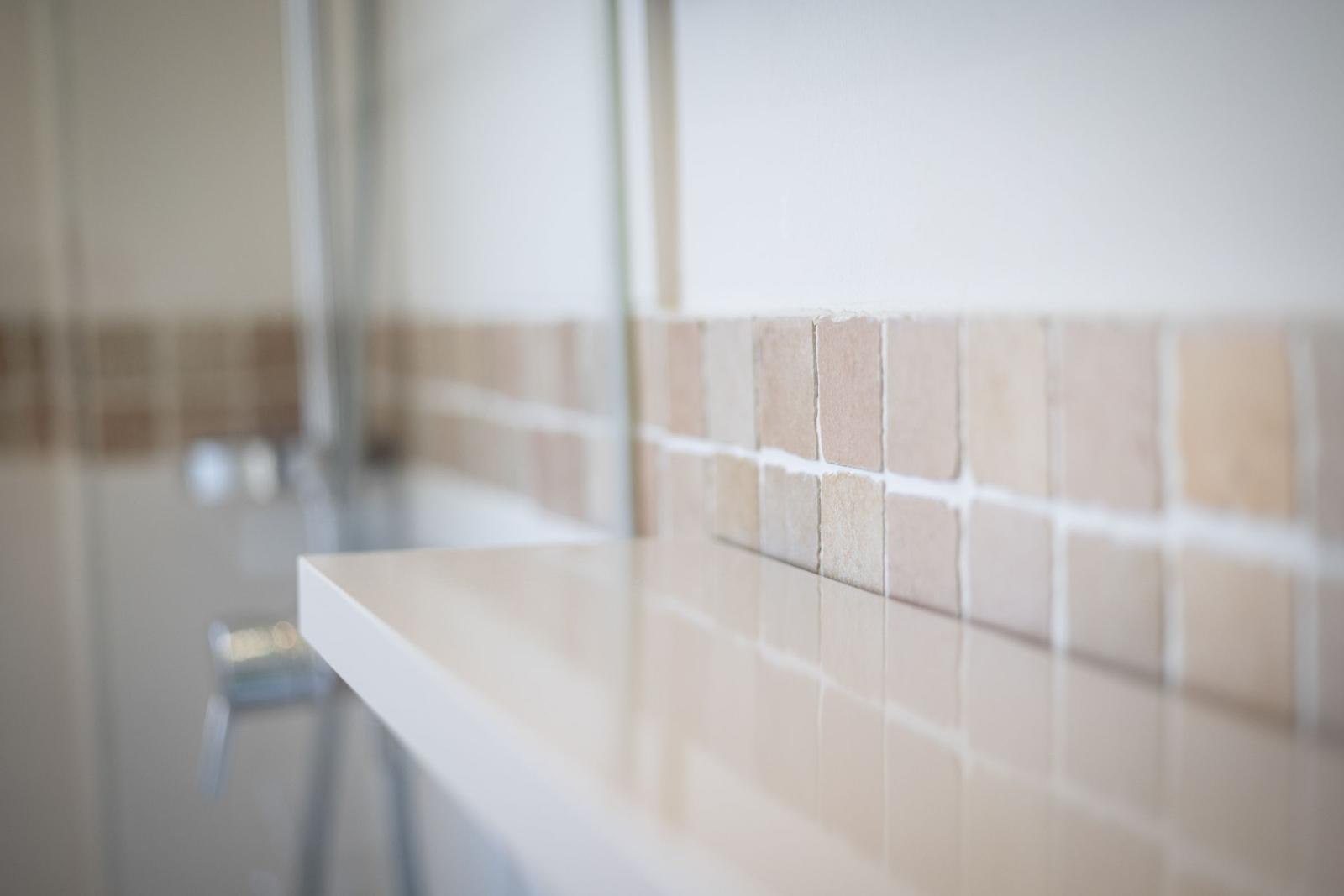 Bathroom with light tiles and sink