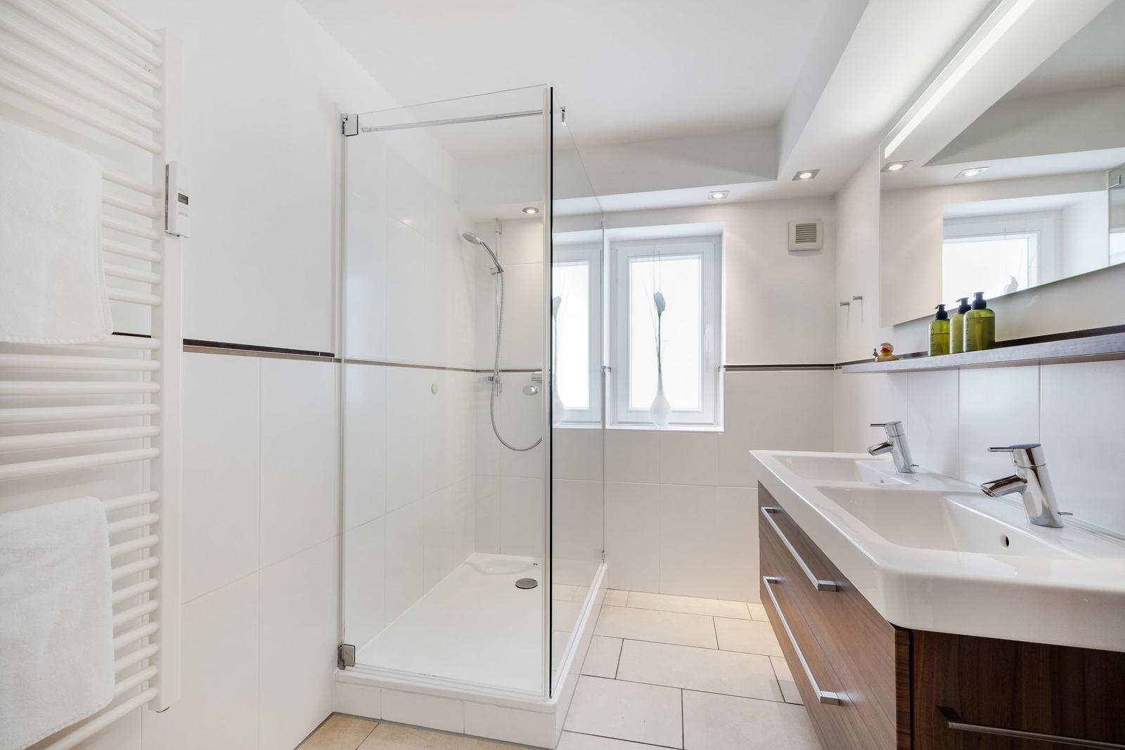 Bathroom with shower, sink and heater