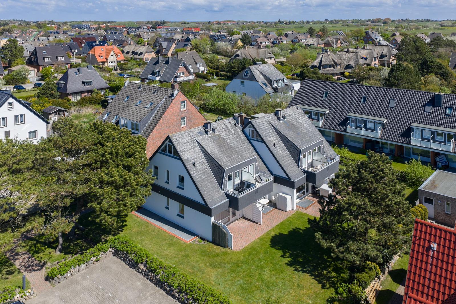 Modern house with balcony and garden in quiet residential area with view of surroundings.