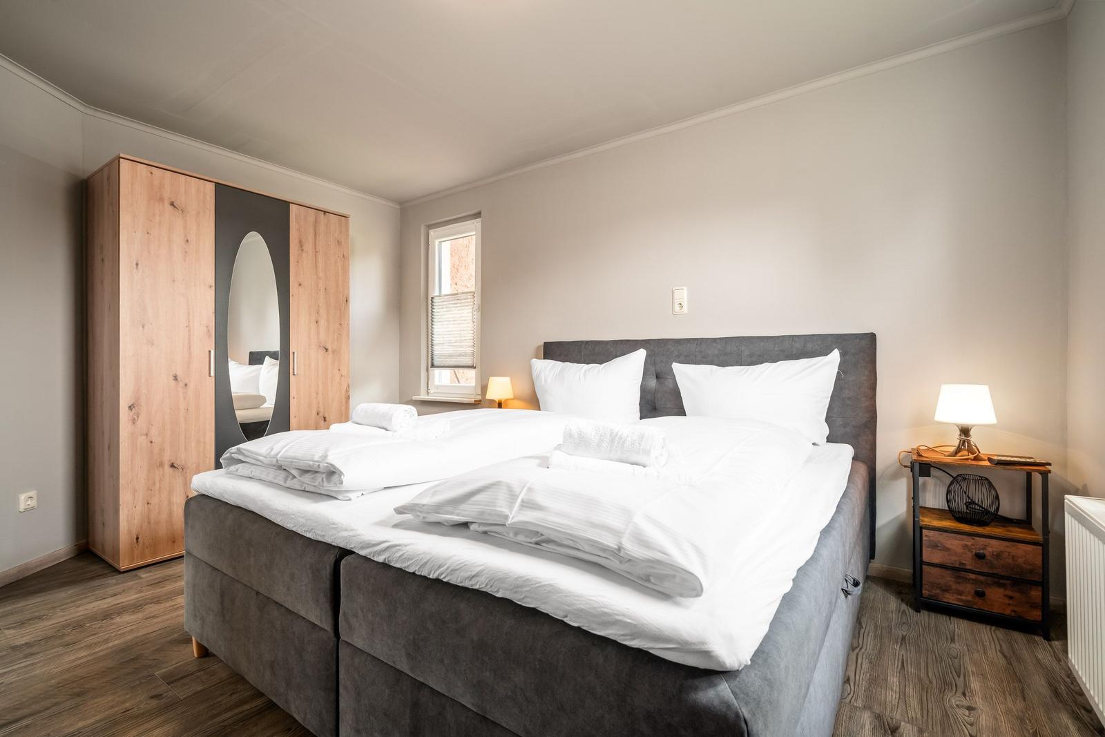 Schlafzimmer mit Doppelbett, Kleiderschrank und Nachttisch