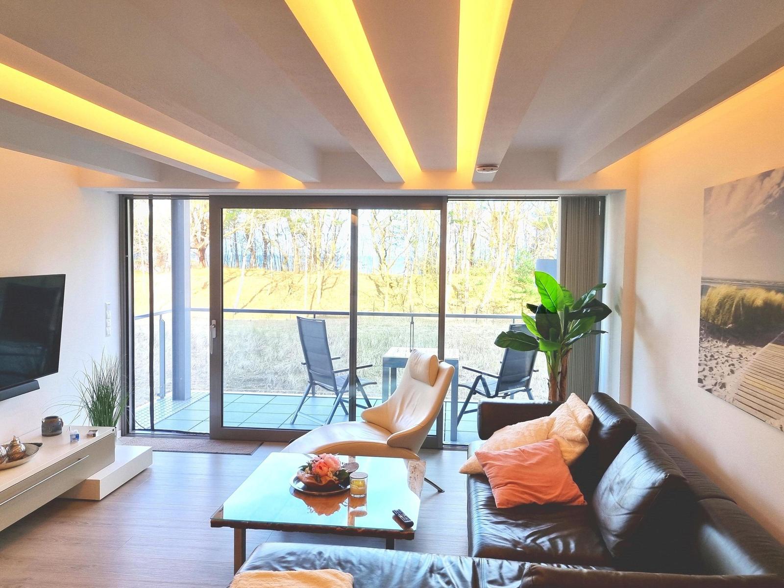 Wohnzimmer: Essbereich, Schlafsofa, Elektro-Kamin, Smart- TV, Zugang zum Balkon