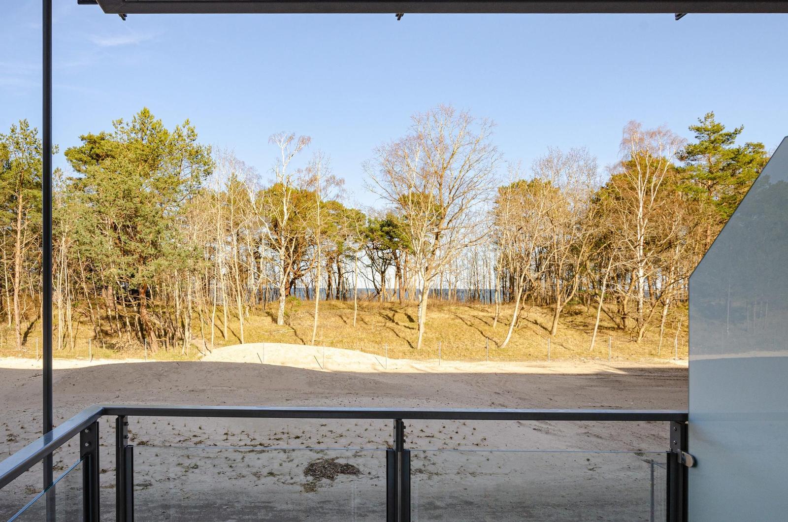 Blick von Balkon auf Wald und Strand