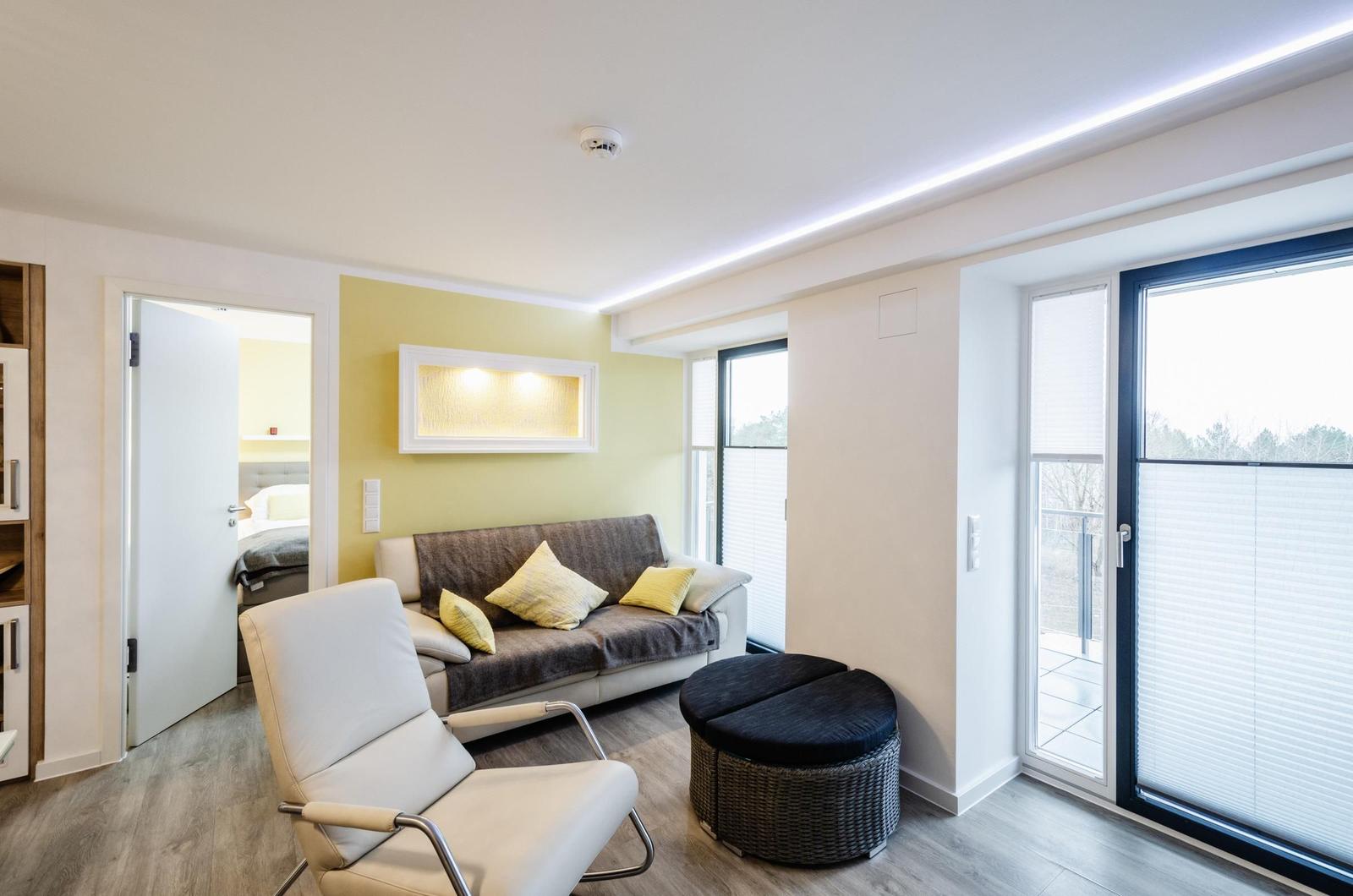 Wohnzimmer: Schlafsofa, TV, Essbereich, Zugang zum Balkon