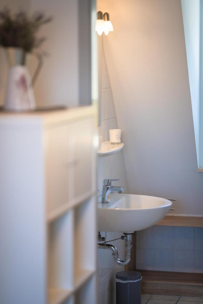 Bathroom with sink, mirror, and small window