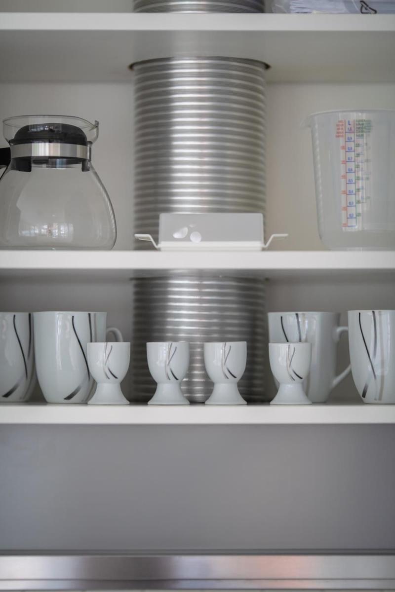 Kitchen shelf with cups, carafe, and measuring cup