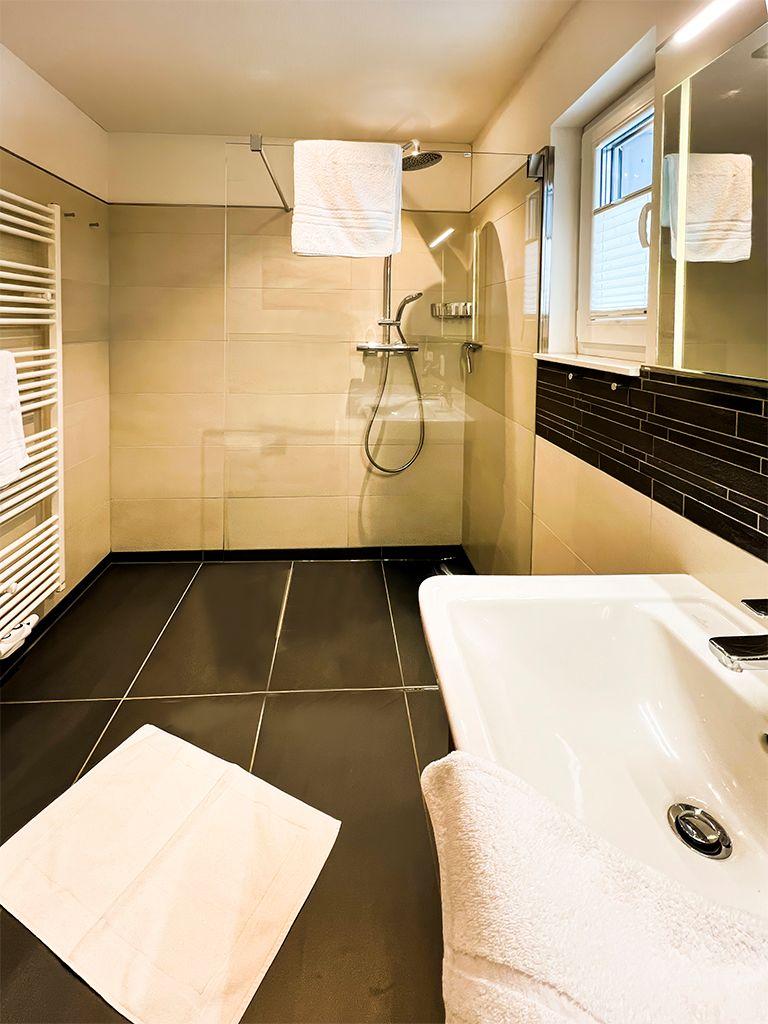Bathroom with shower, bathtub, and heater