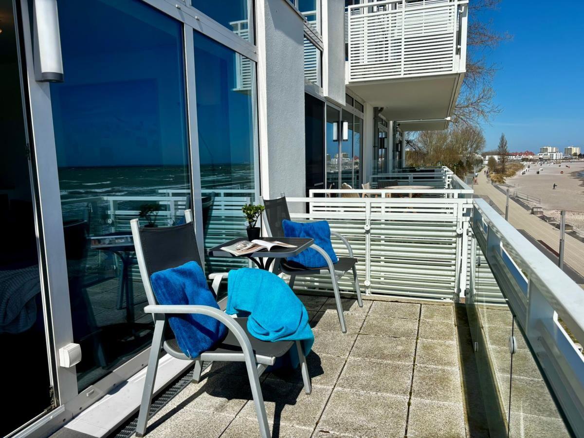 Terrasse mit zwei Stühlen und Tisch. Blick auf Strand und Meer.