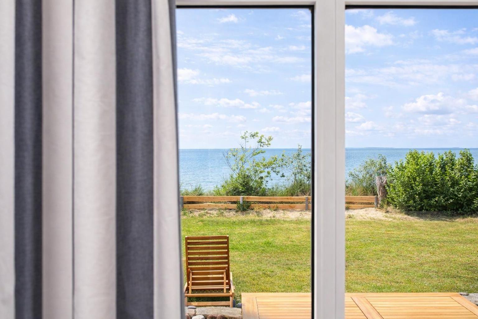Through the window, you can see the beach and the sea.