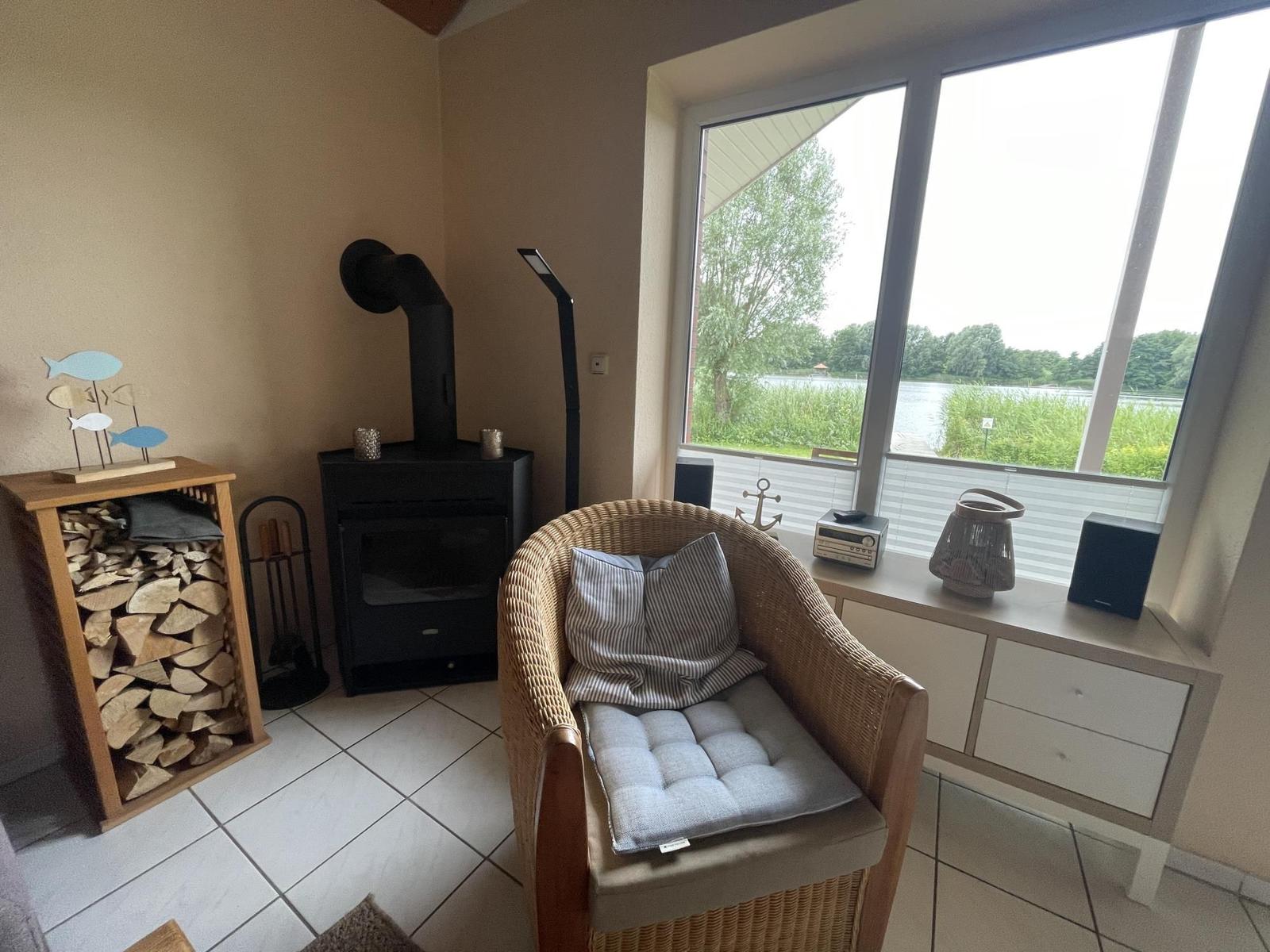 Room with armchair, wood stove, and view of water