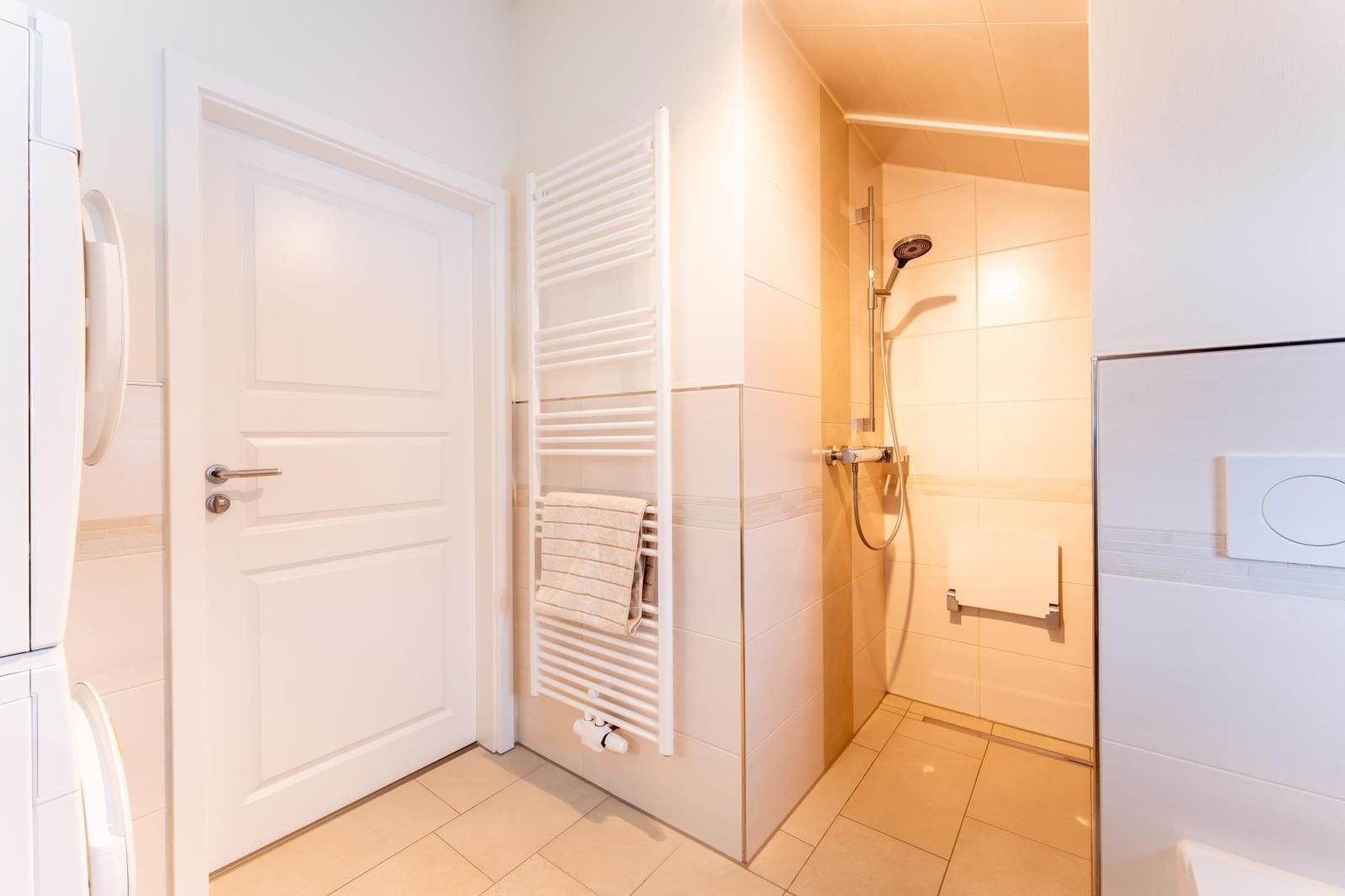 Bathroom with shower, heater, and toilet