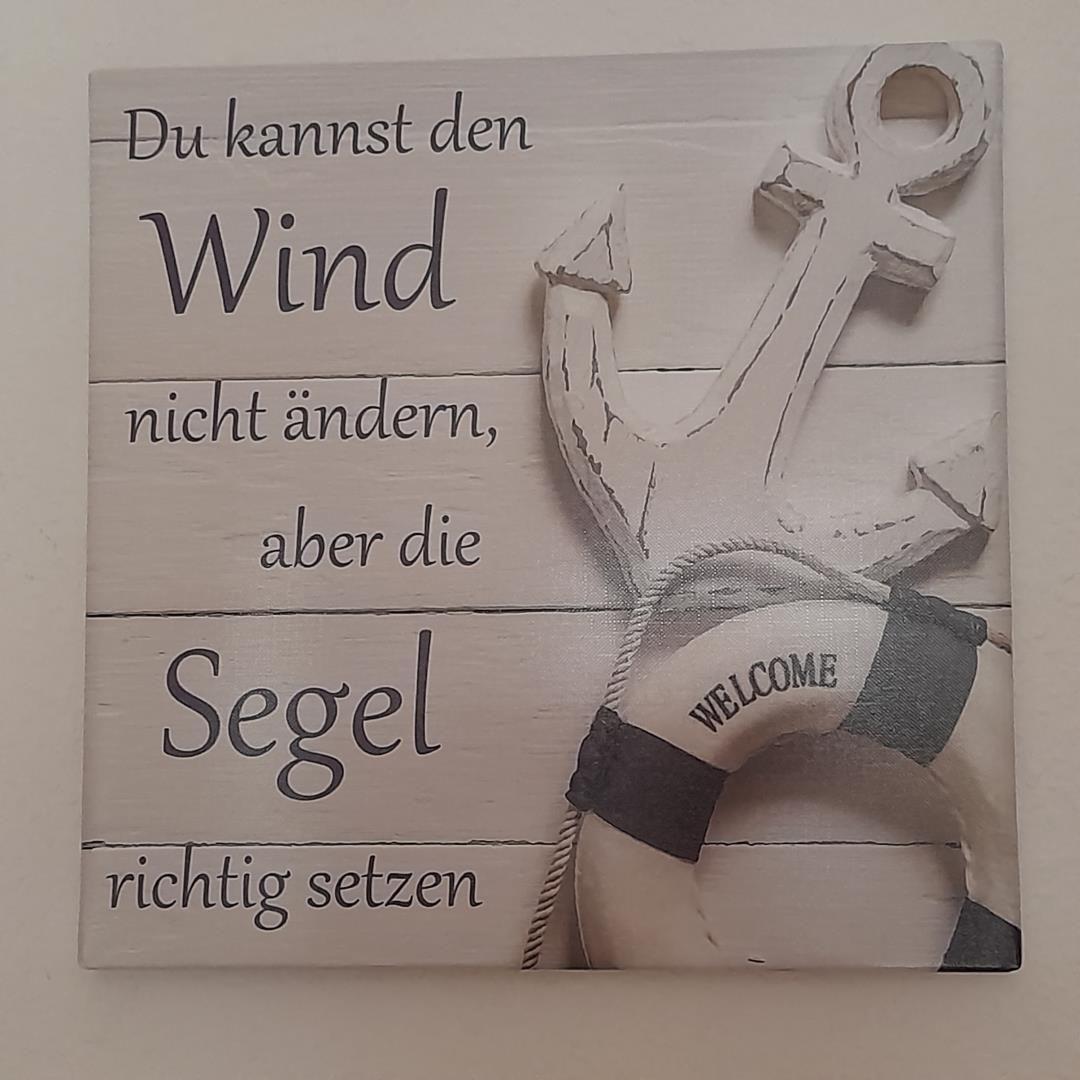 Wooden sign with sailboat decor and welcome message