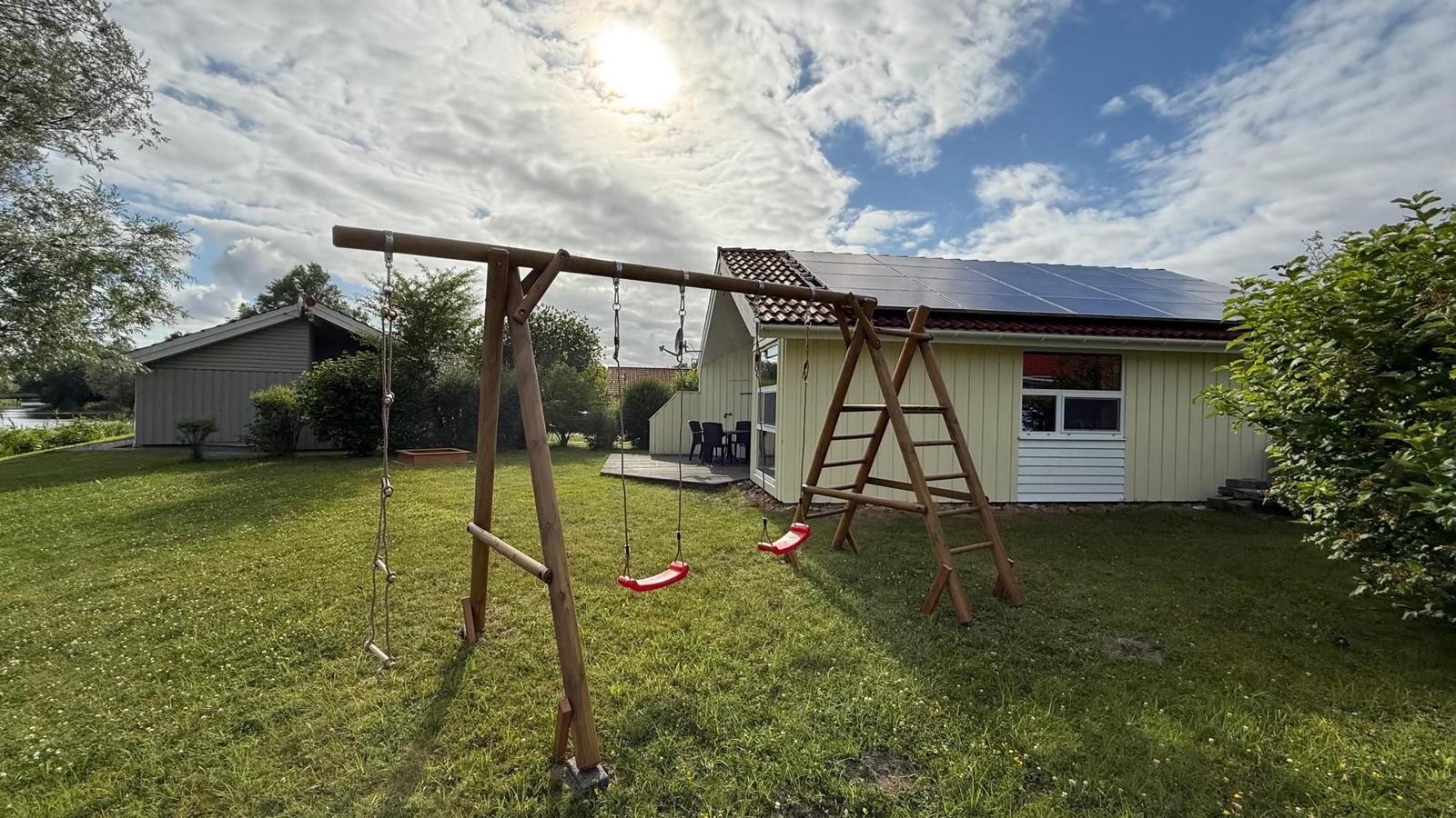 Backyard with playground equipment and solar panels on the roof