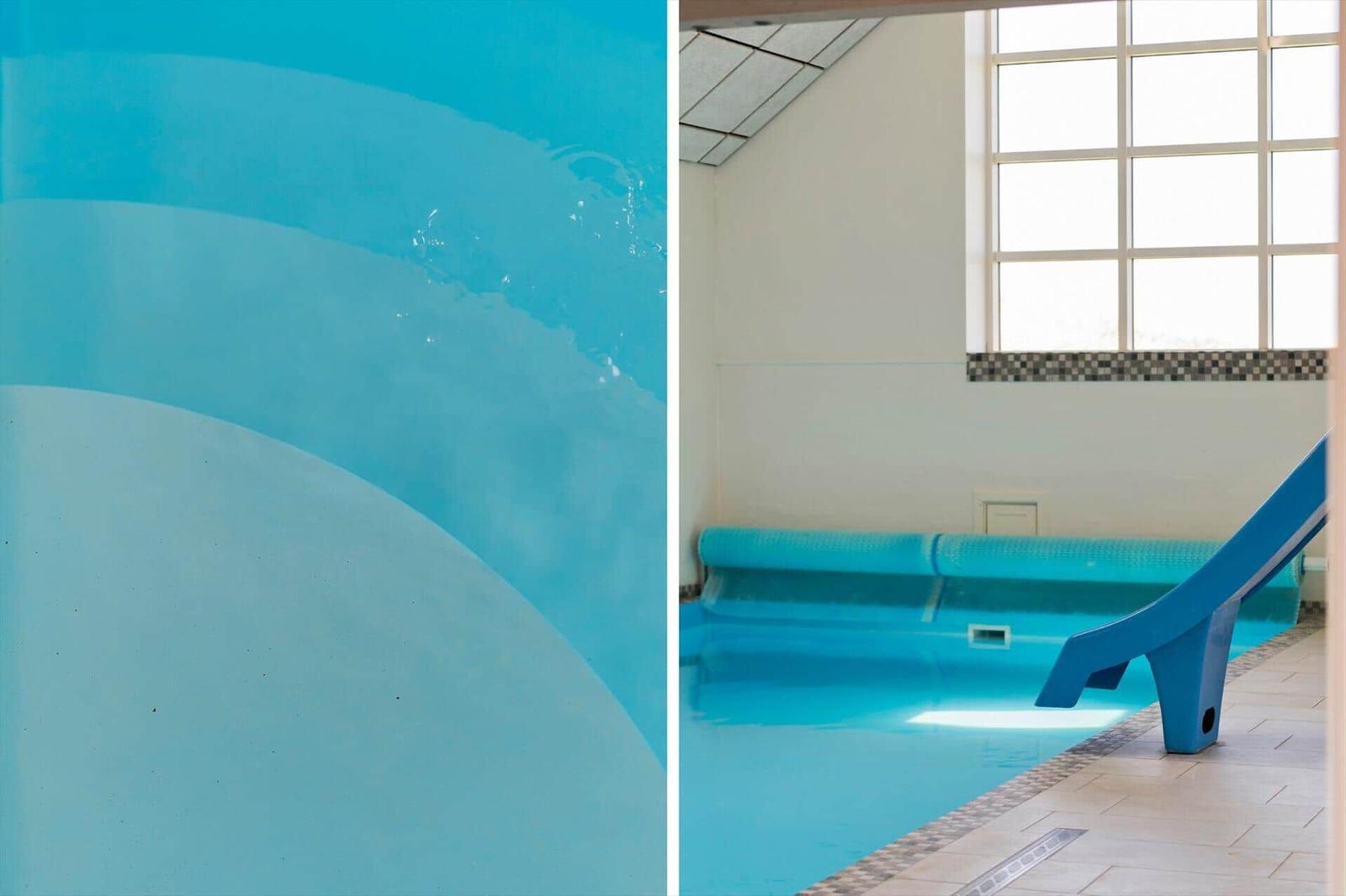 Innenpool mit blauer Rutsche und großem Fenster