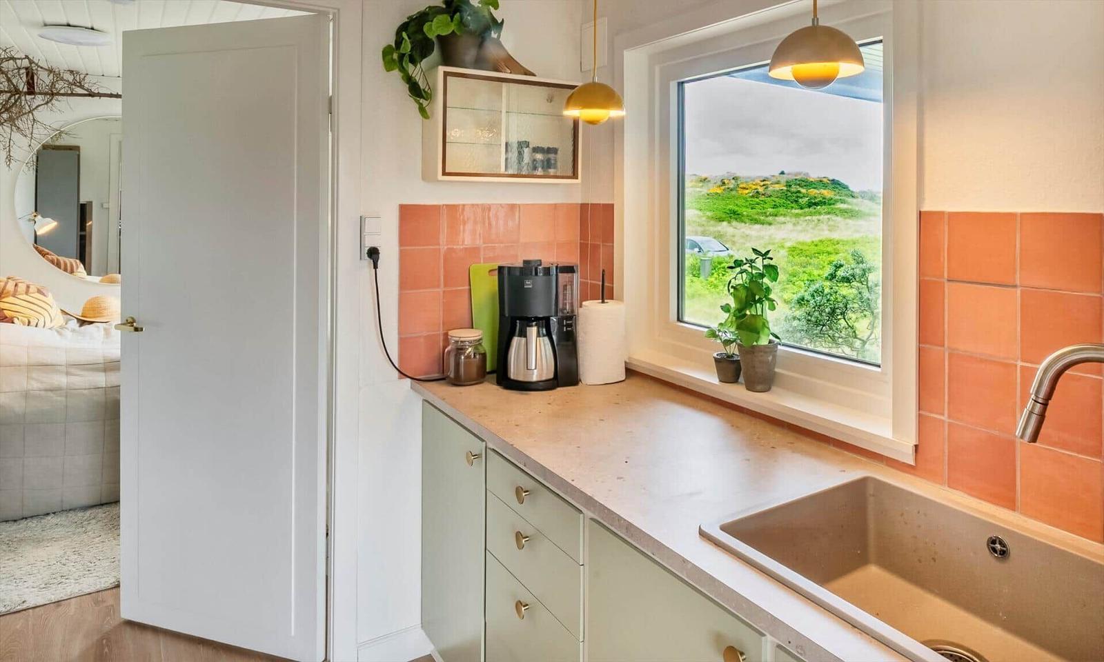 Kitchen with countertop, sink, and view of green areas