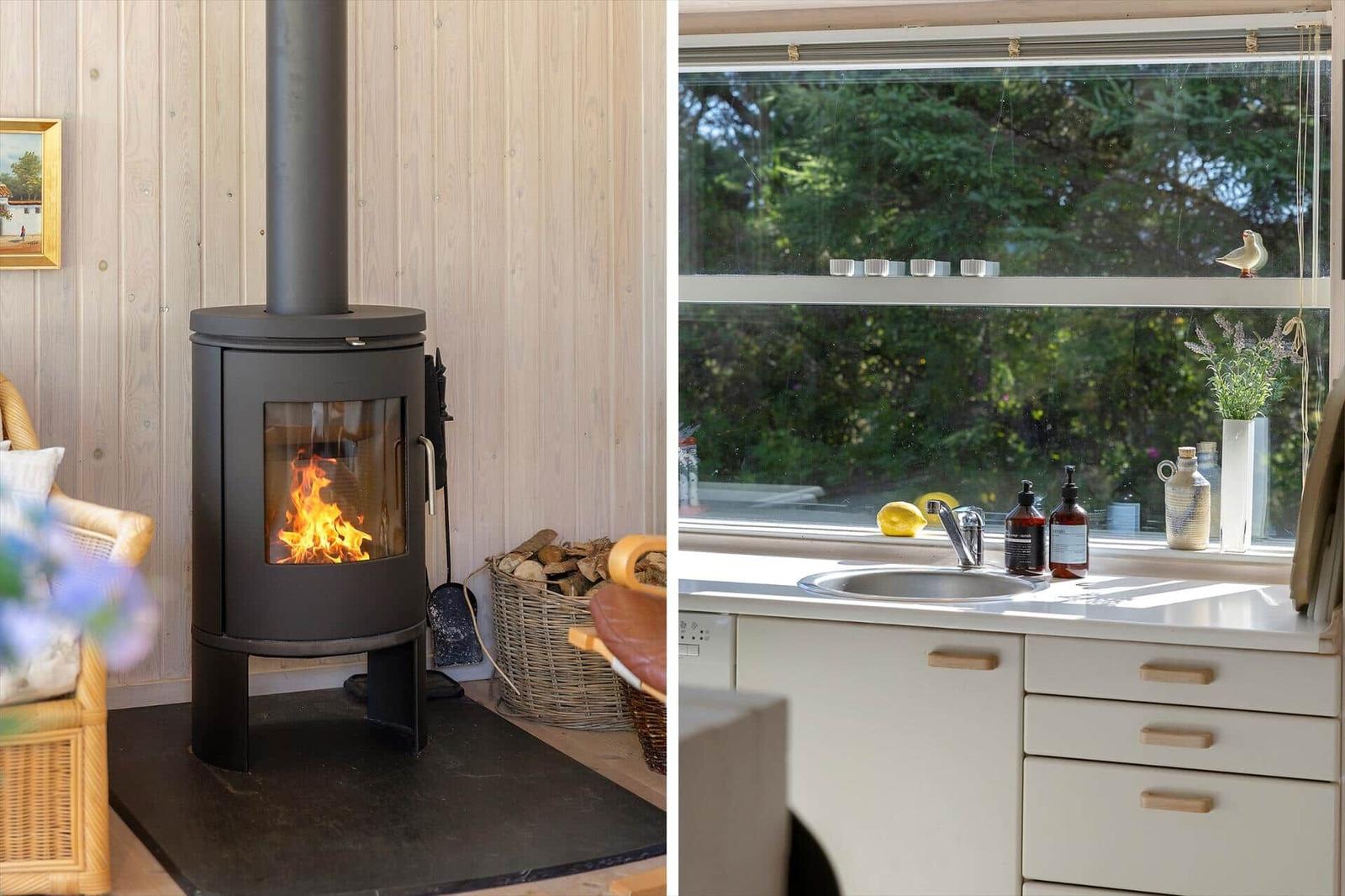 Kaminofen mit Holzstapel und Küchenfenster mit Waschbecken