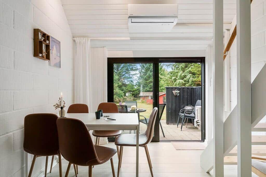 Dining area with table, chairs, and view of garden