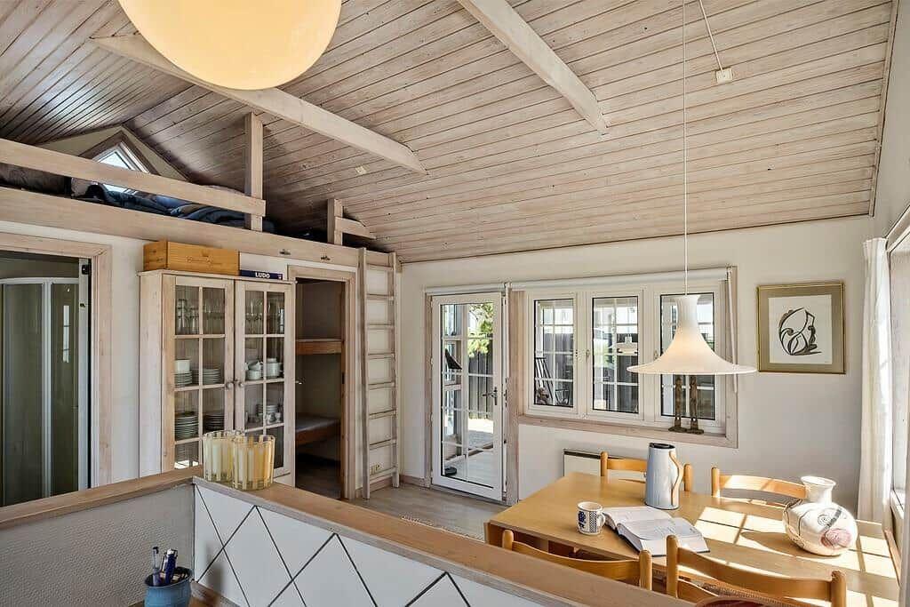 House with dining area, wooden ceiling, and bunk bed.