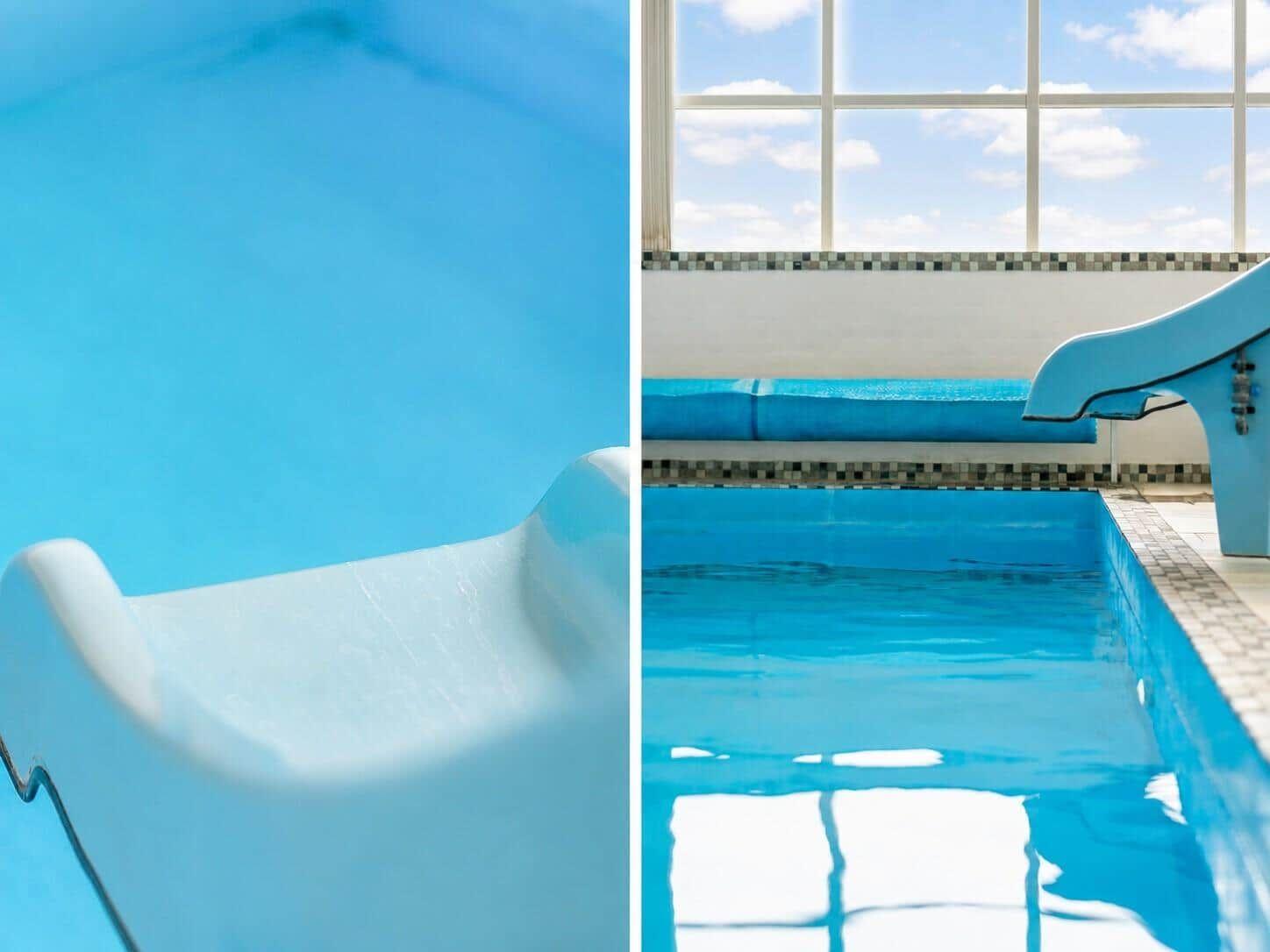 Ein blauer Wasserslide führt in einen Pool mit Blick auf ein großes Fenster.