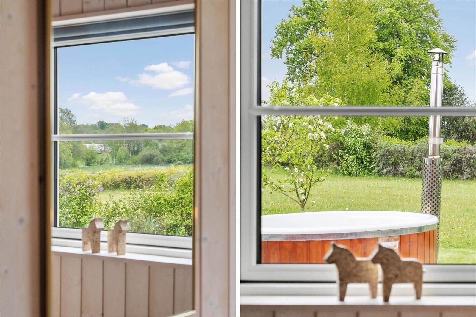 Through the window, you see a garden with a hot tub and trees.