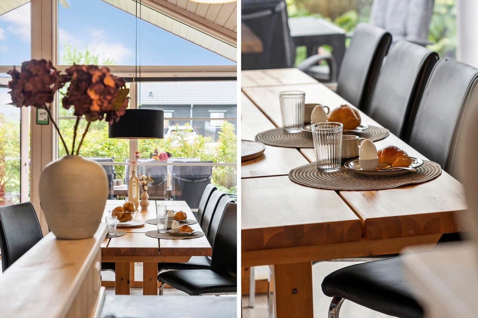 Dining room with wooden table, black chairs, and view of garden.