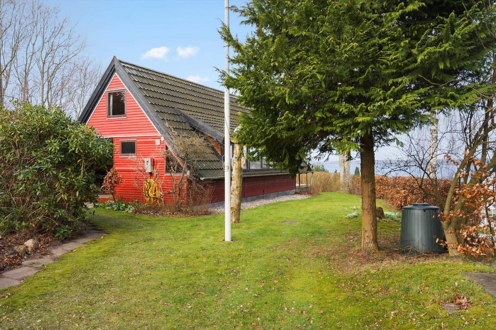 Rotes Haus mit Garten und Blick auf Wasser