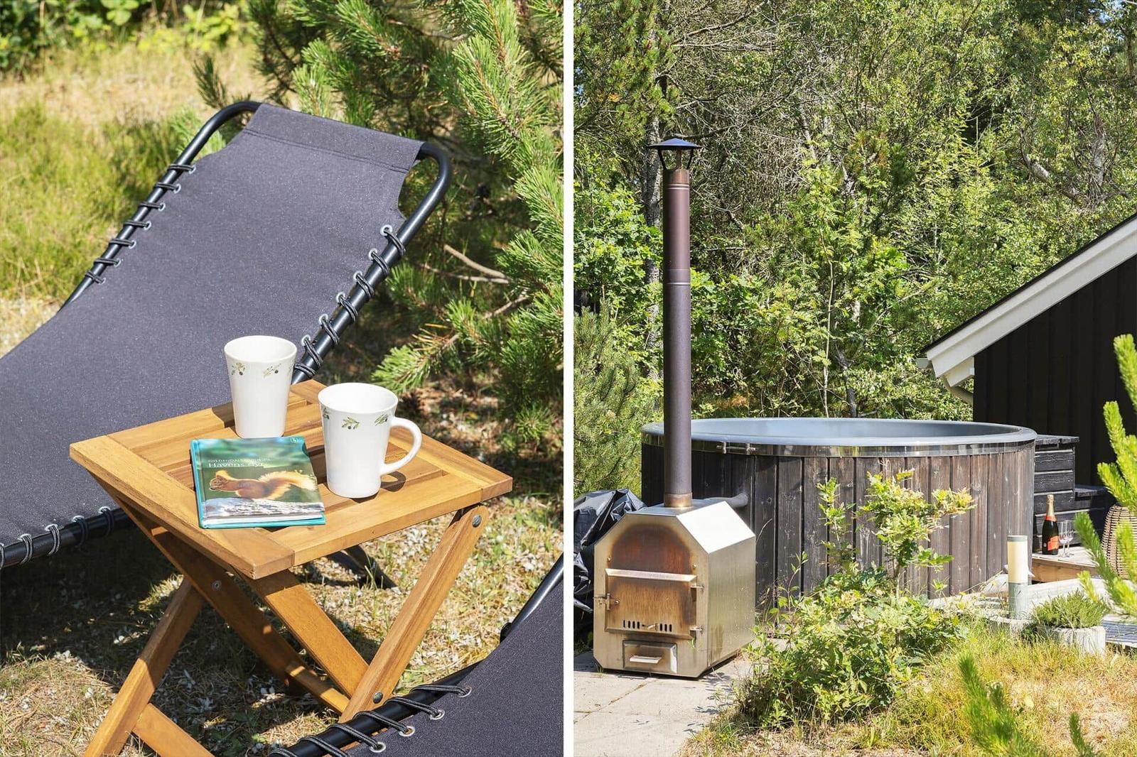 Outdoor area with lounge chair, table, book, and mugs. Wooden hot tub with stove and grill in garden.