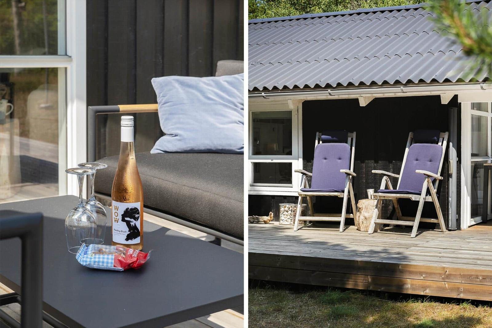 Terrace with seating and wine bottle. Porch with two chairs and wooden deck.