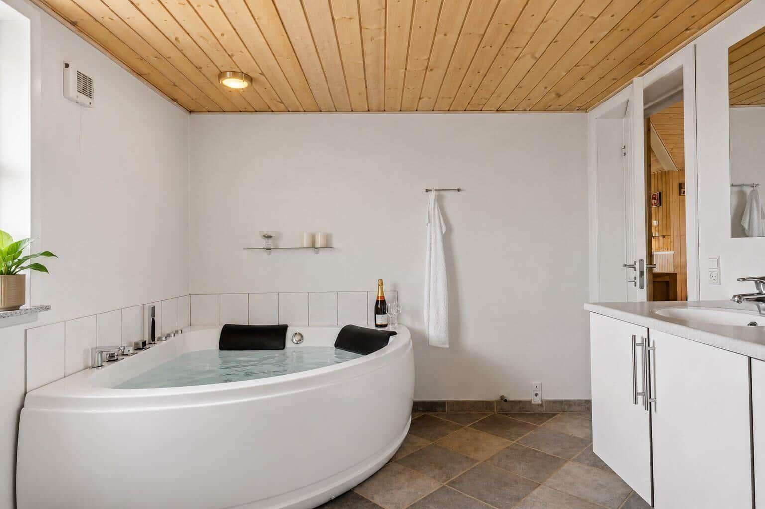 Bad mit Whirlpool, Holzdecke und Waschtisch