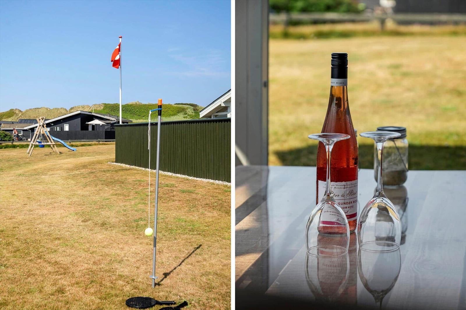 Außenbereich mit Schaukel und dänischer Flagge. Tisch mit Rosé und Gläsern im Freien.