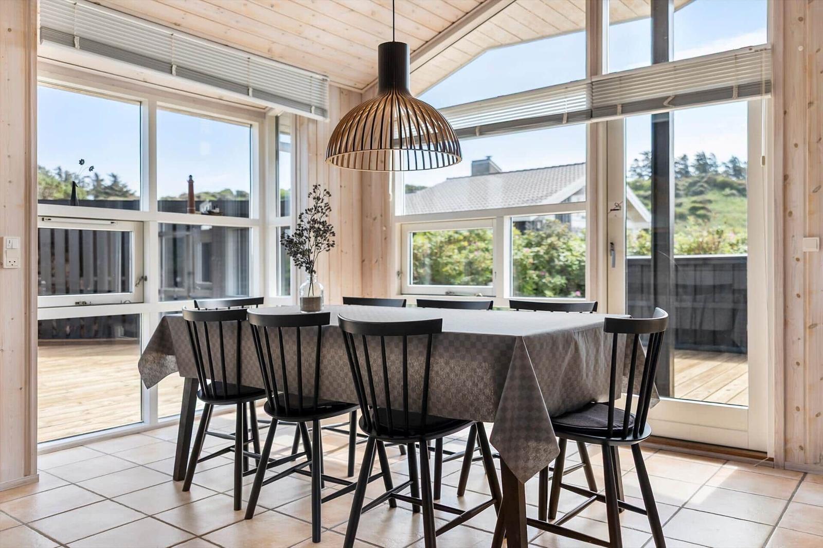 Dining room with table, chairs, and large window to terrace.