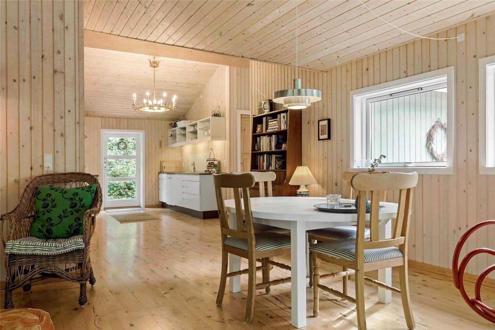 Dining room with table, chairs, and view into the kitchen.