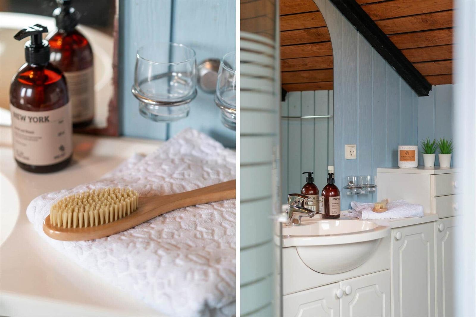 Badezimmer mit Dusche, Waschbecken und Toilette unter Holzdecke.