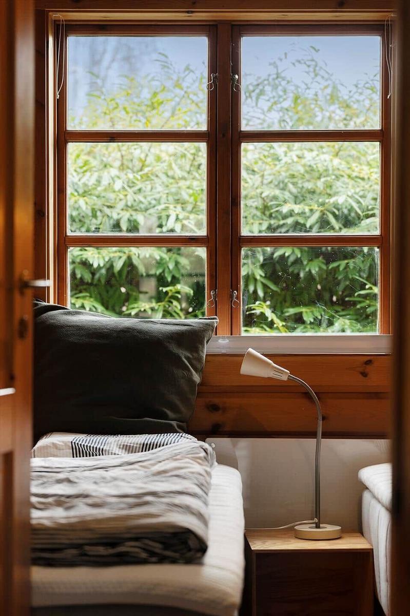 Through open door, view of green grass and leafless trees.