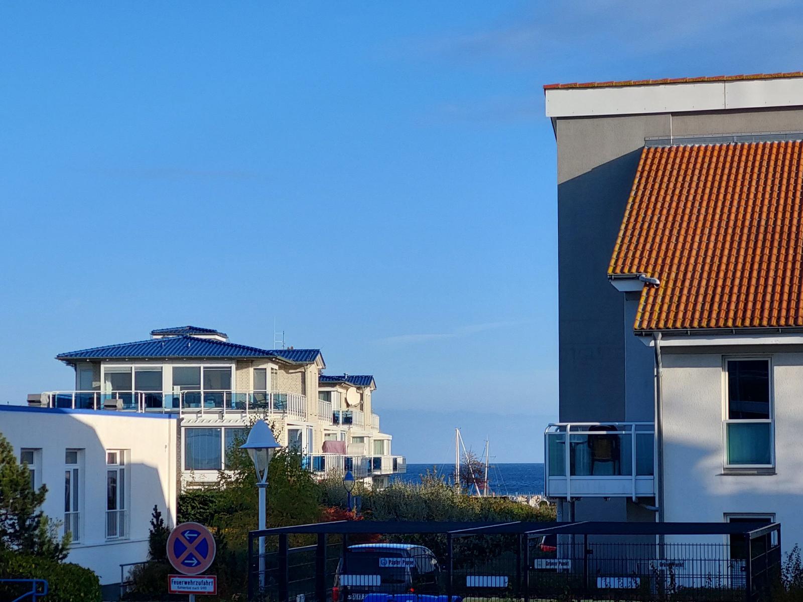 Villa with terrace and sea view. Red roof and blue sky.