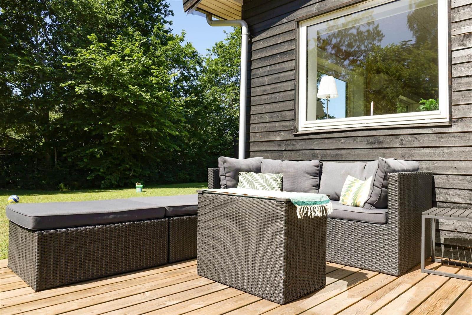 House with terrace, seating area, and fire pit in the garden