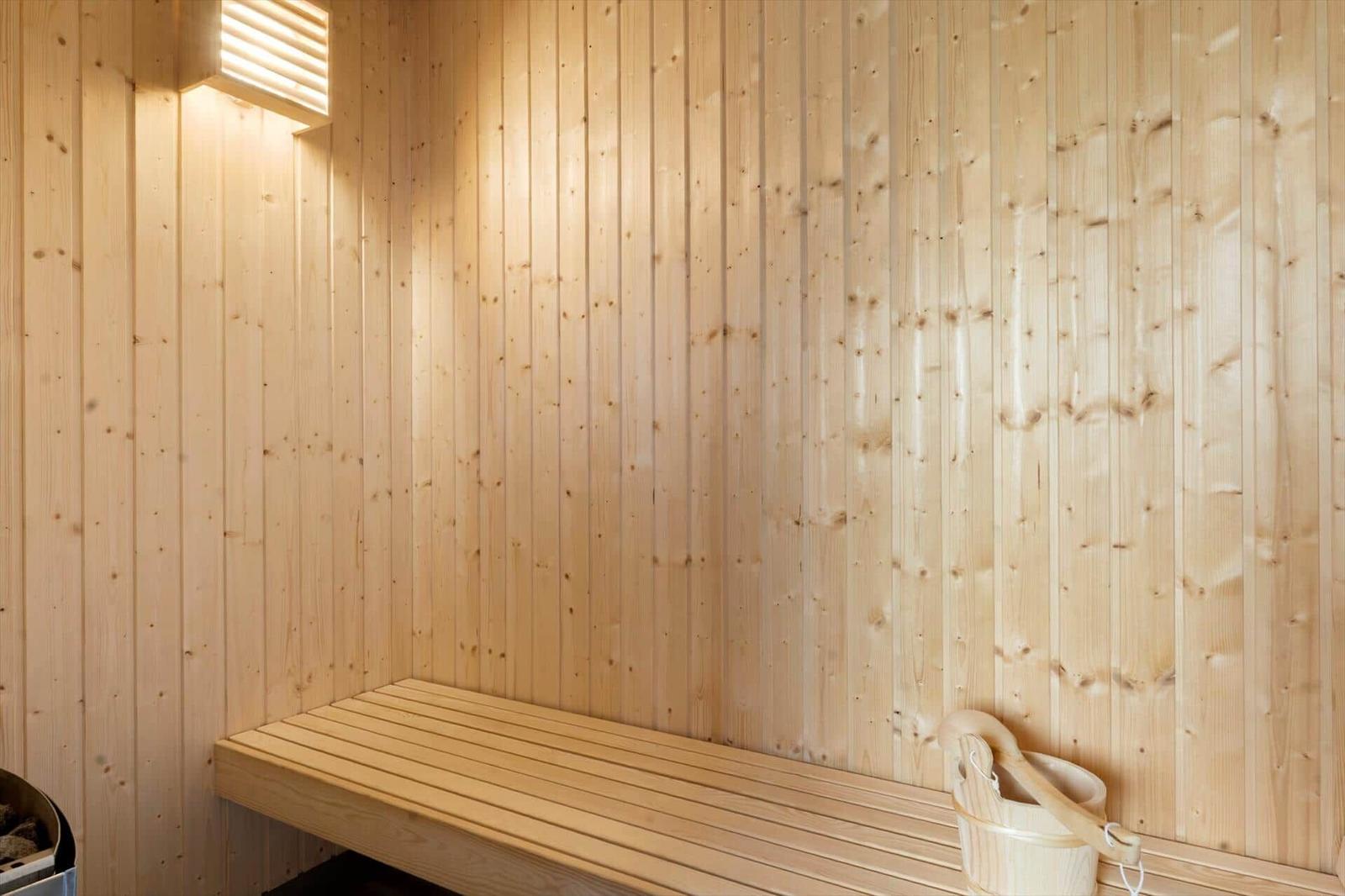 Entrance area with white cabinets, wooden wall, and door to outdoor space.