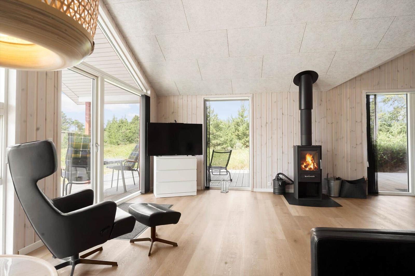 Kitchen with dining area, wood wall, and fireplace