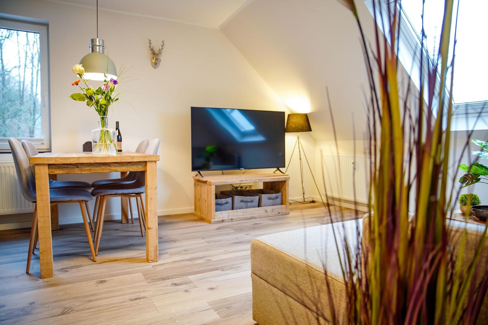 Wohnung mit Schlafzimmer, Küche und Bad. Holzboden und moderne Einrichtung.