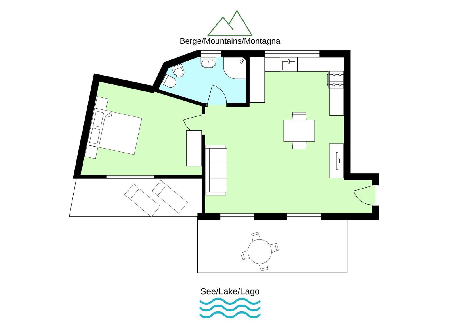 Lage am See mit Bergen im Hintergrund und blühenden Pflanzen im Vordergrund.