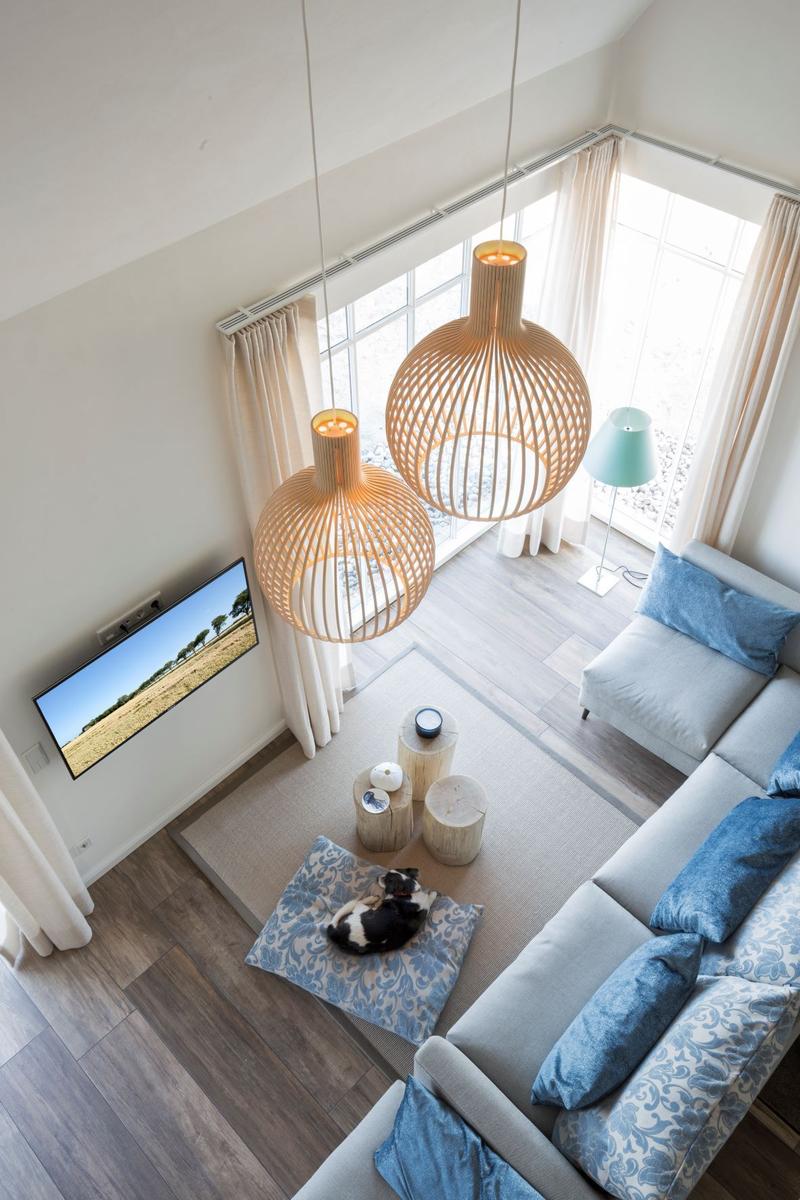 Schlafzimmer mit Bett, Fenster und Stehlampe.