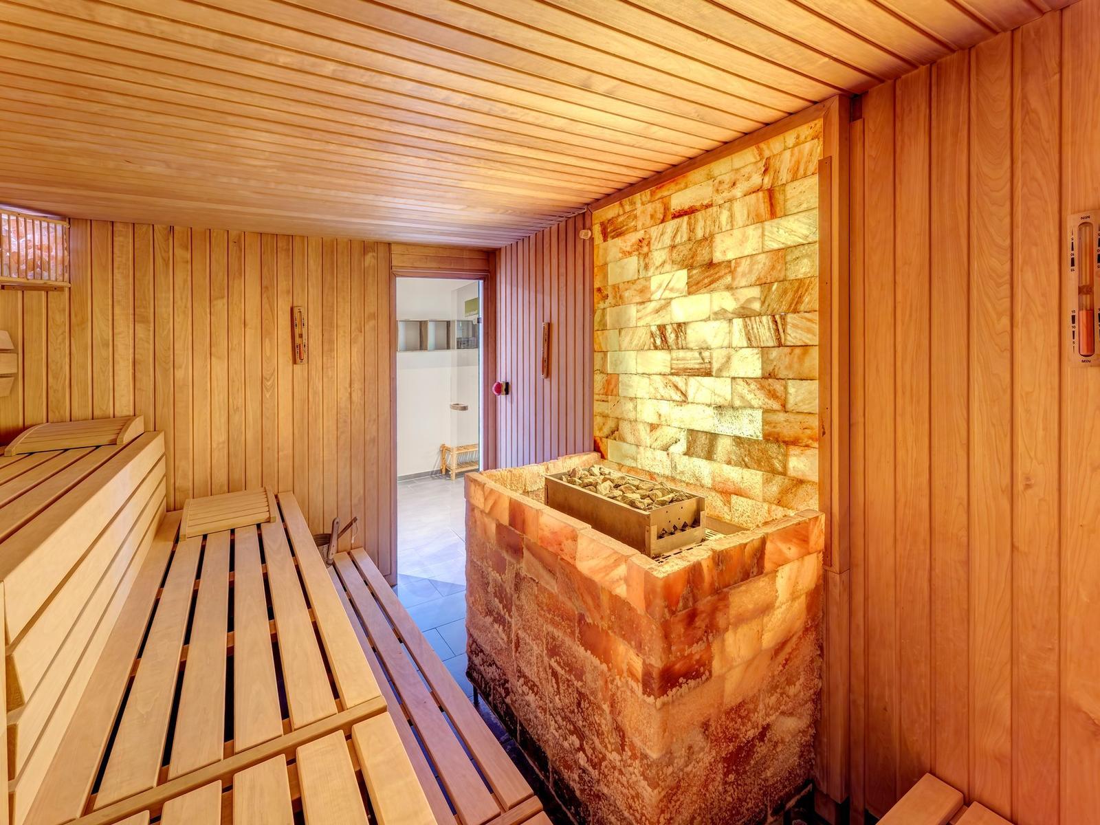 Fitness room with stationary bike, dumbbells, and climbing bars.