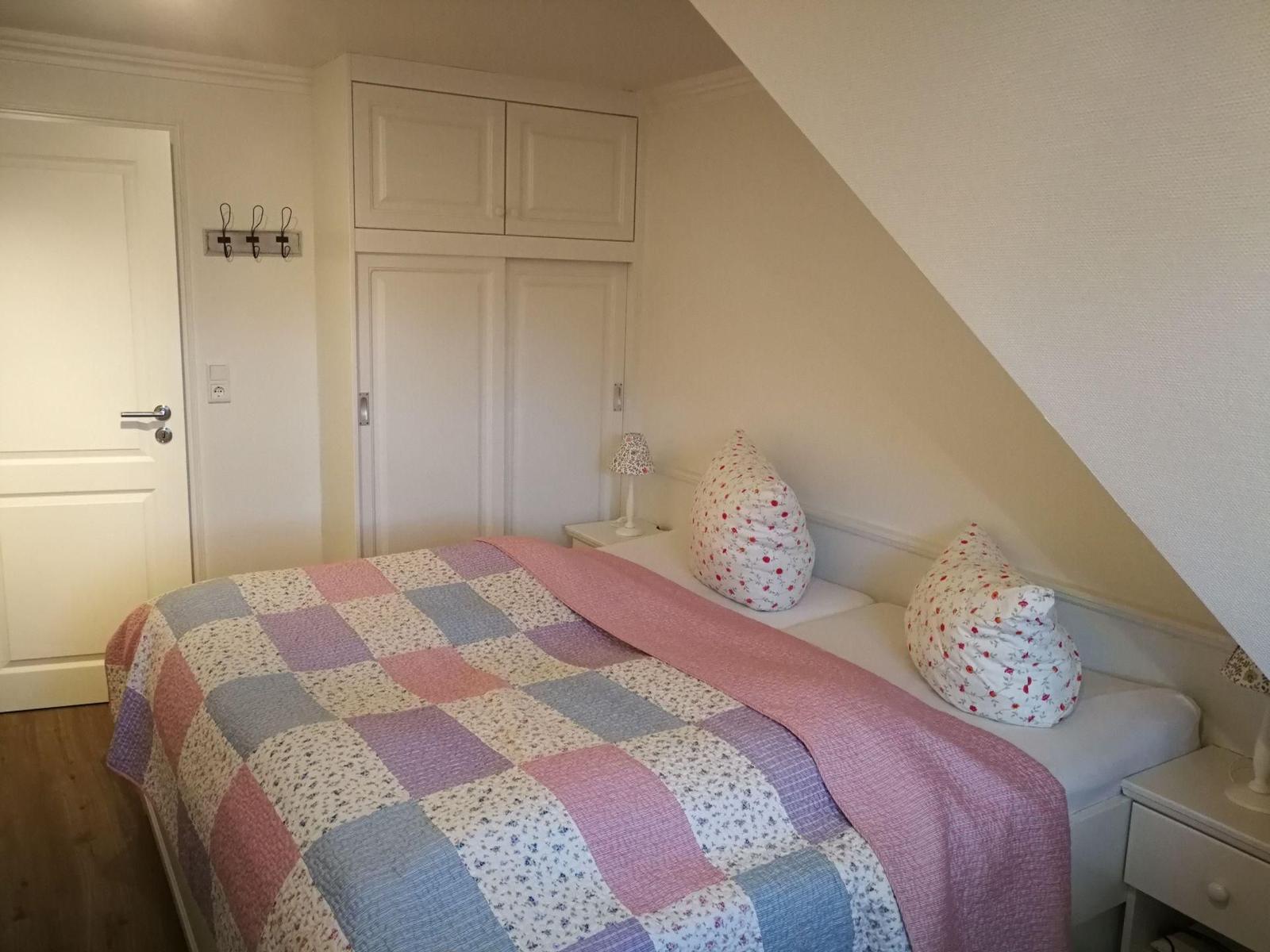 Badezimmer mit Dusche, Toilette und Heizkörper an der Wand.
