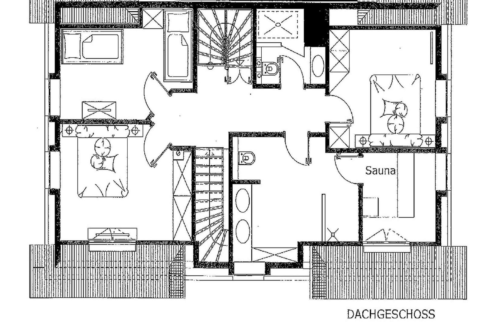 Haus mit strohgedecktem Dach und Steinmauer im Garten