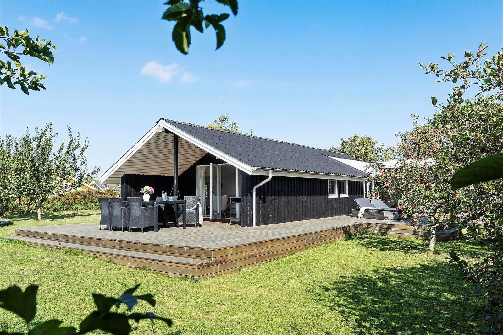 House with terrace, grill, and seating under roof