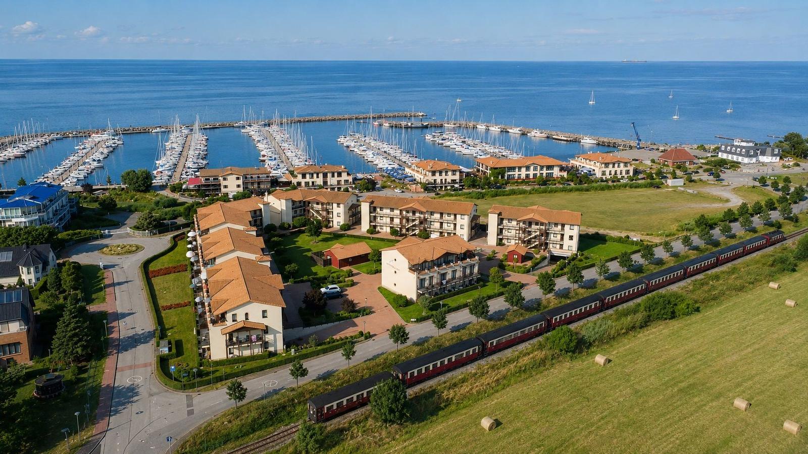 Ferienwohnung mit Meerblick und Yachthafen im Hintergrund.