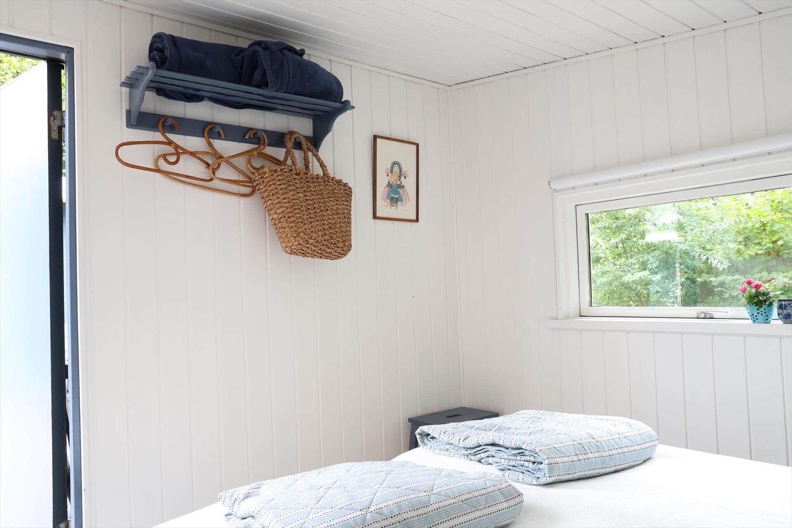 Entrance area with coat hooks and view into the kitchen.