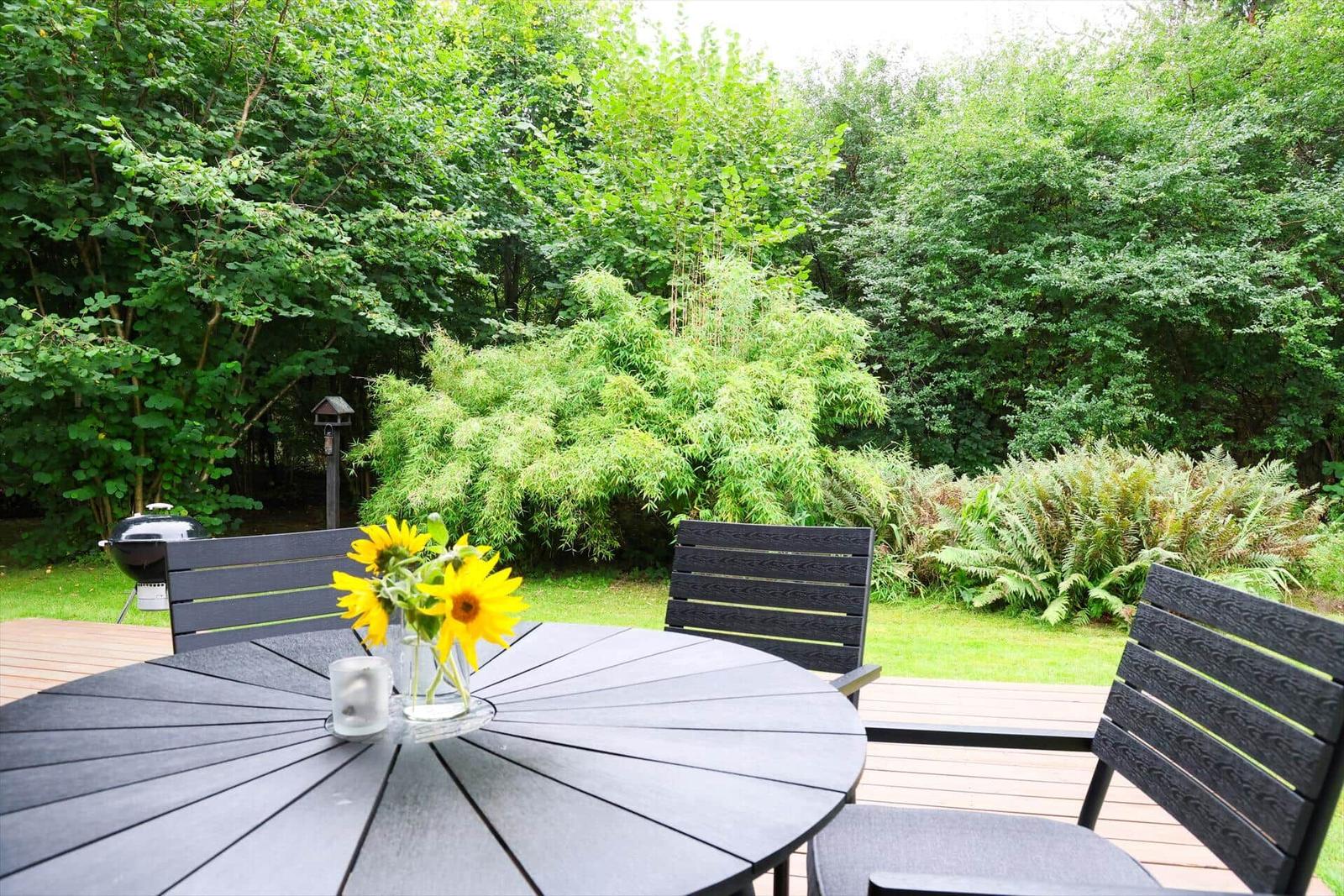 Open space with dining area, sofa, and view of the garden.