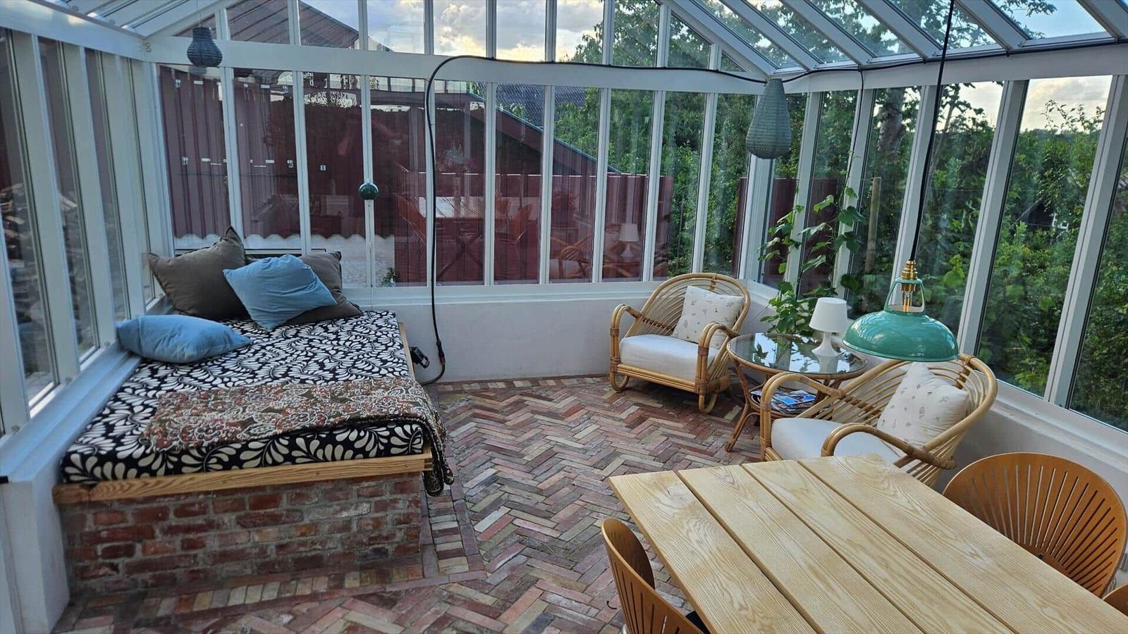 Glasshouse with seating and garden area