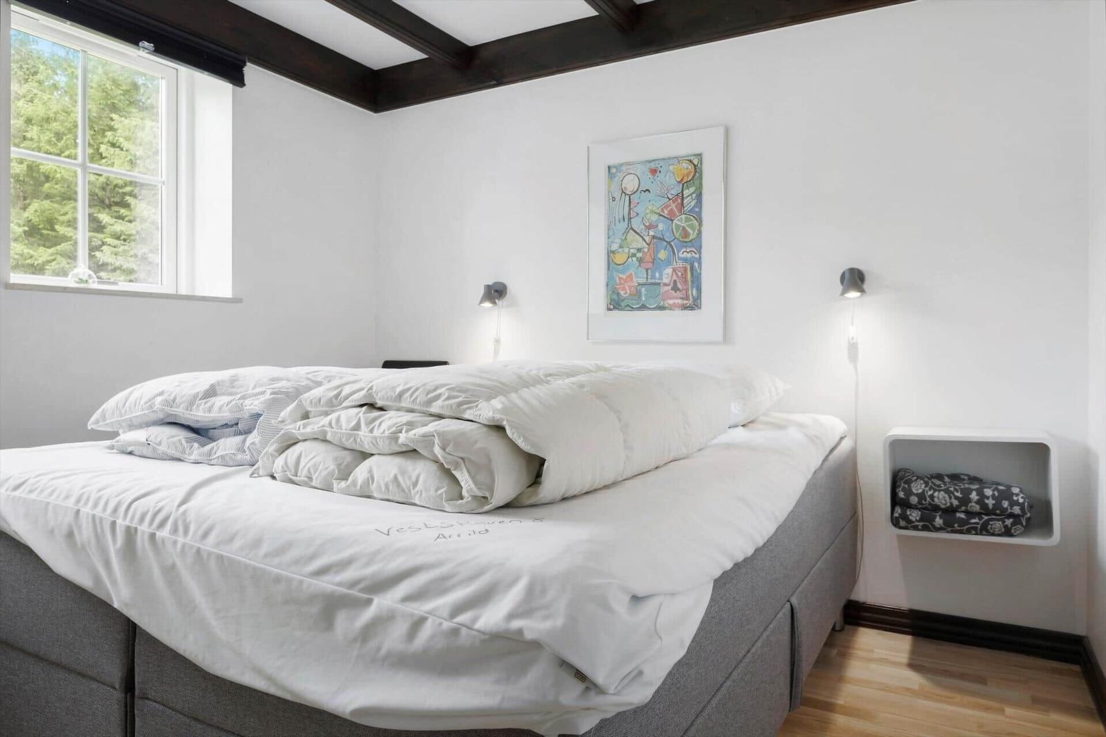 A room with fireplace, wooden floor, and seating. Access to outdoor area.